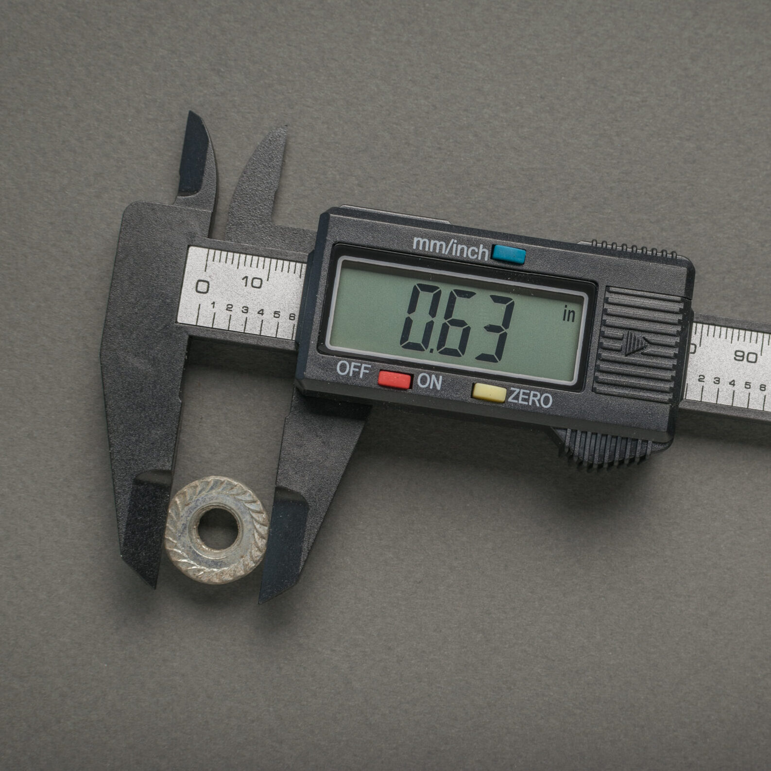 measuring-nut-with-electronic-vernier-caliper-gray-background-scaled-e1761675540212.jpg